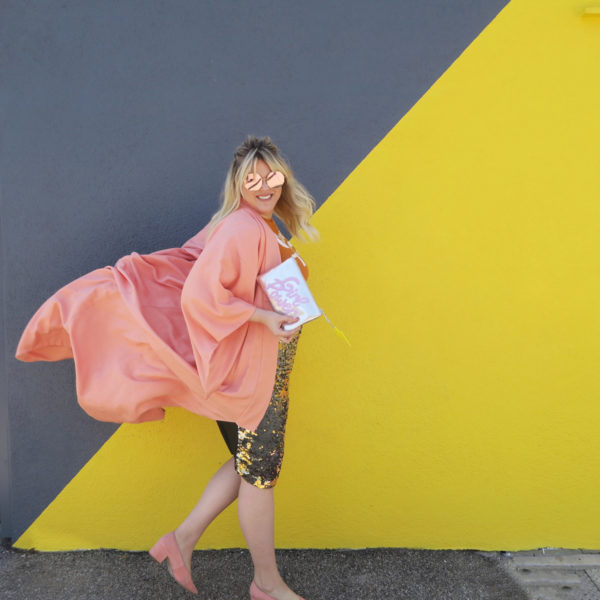 Someone in front of a yellow and grey wall