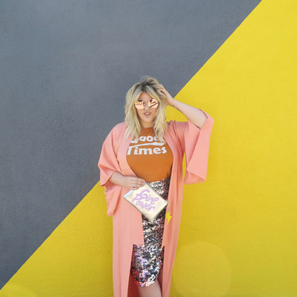 A woman in front of a grey and yellow wall