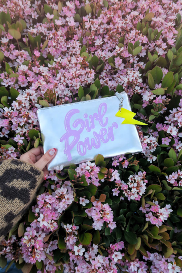 A silver clutch and pink flowers