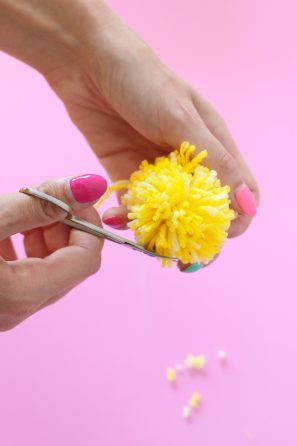 A person holding yellow strings