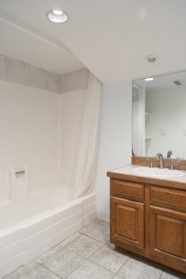 A bathroom with a sink and shower