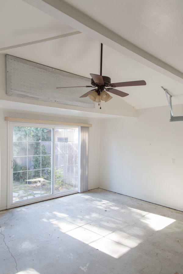 An empty white room with doors