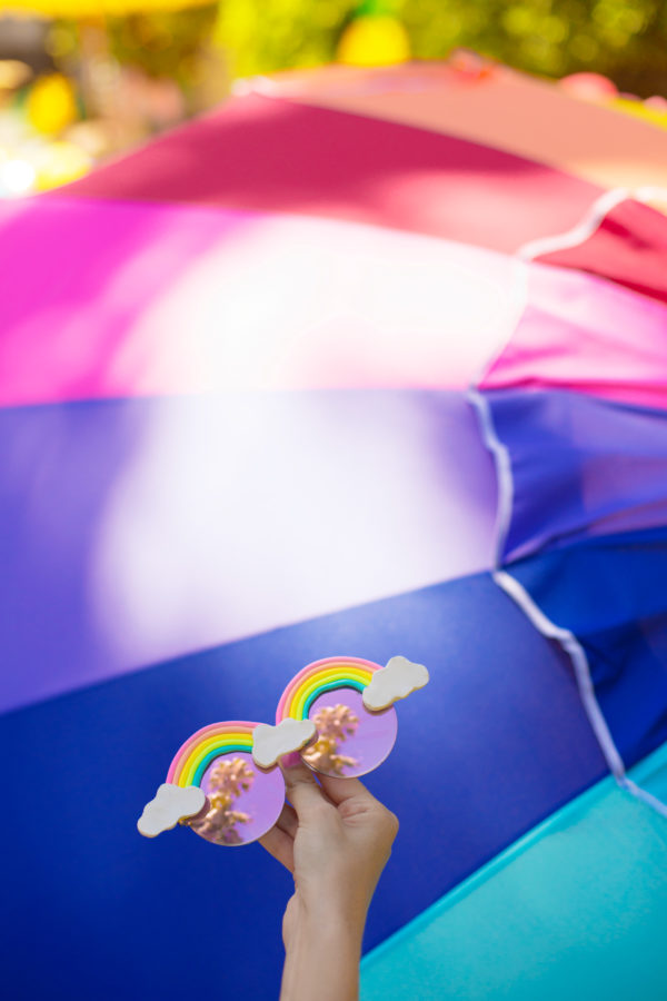 Someone holding rainbow glasses