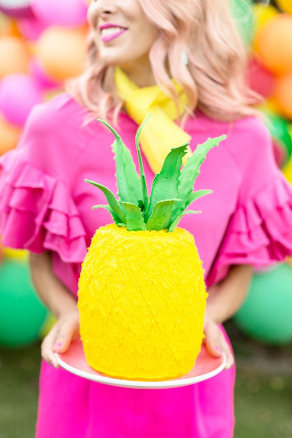 A woman holding a pinapple 