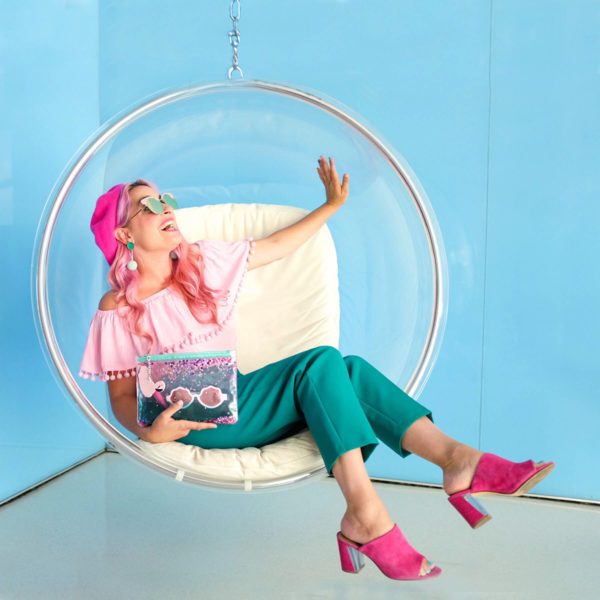 A girl sitting in a bubble chair