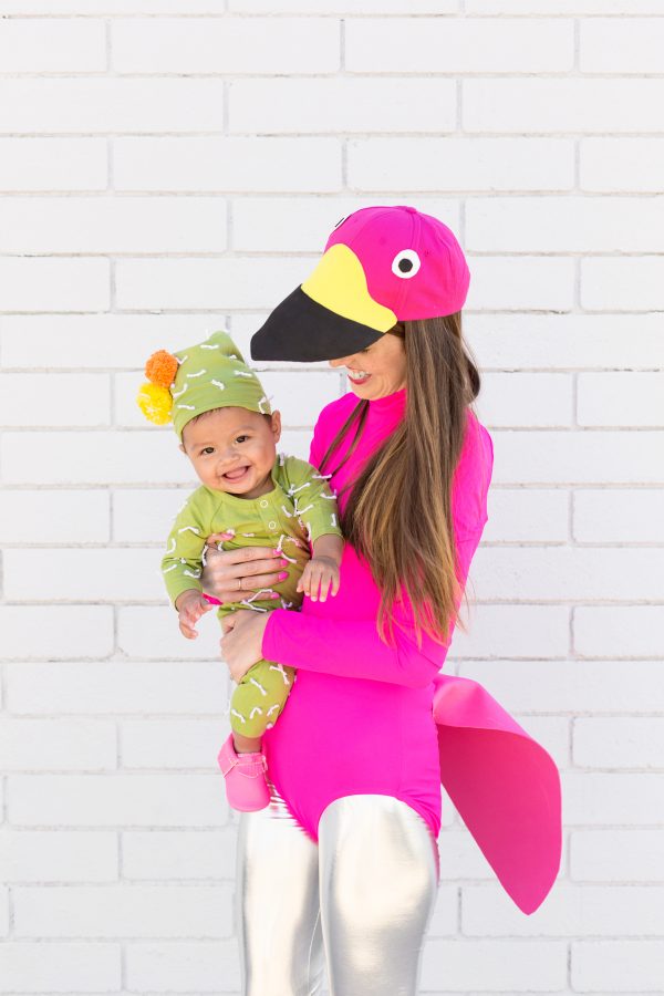 A woman dressed as a flamingo and a little boy dressed as a cactus