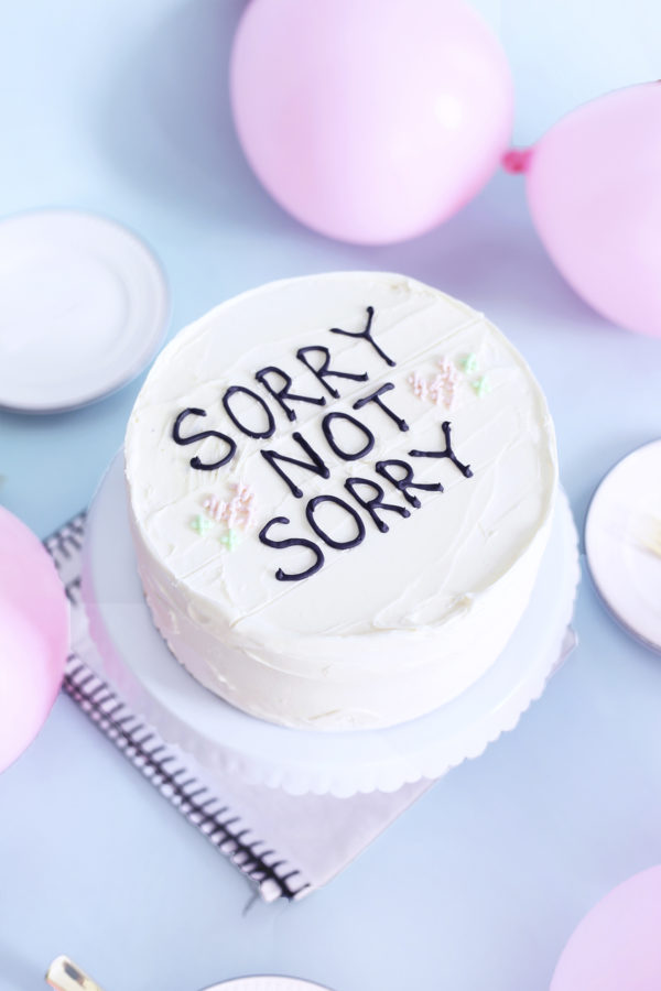 A cake that says \"sorry not sorry\"