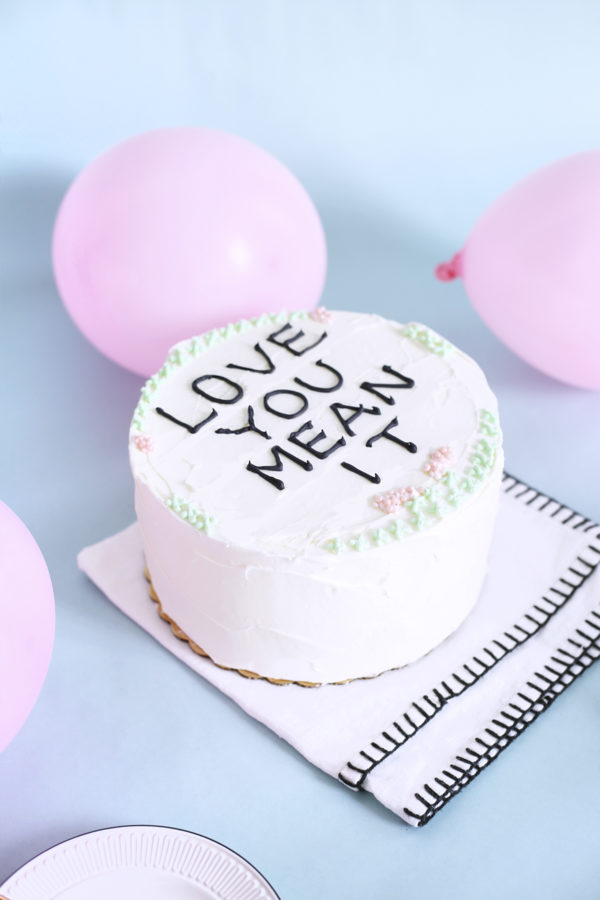 A cake that says \"love you mean it\"