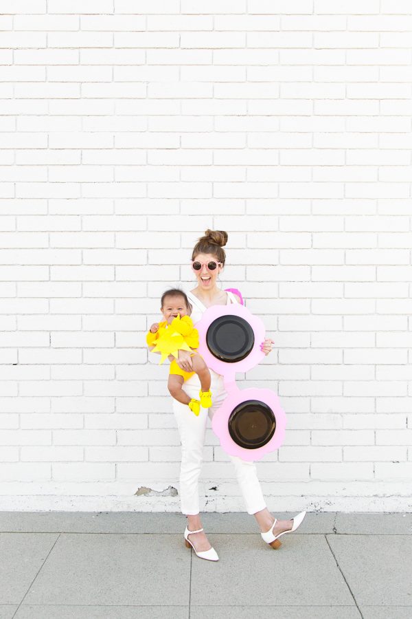 Women and baby dressed up as sun and sunglasses 
