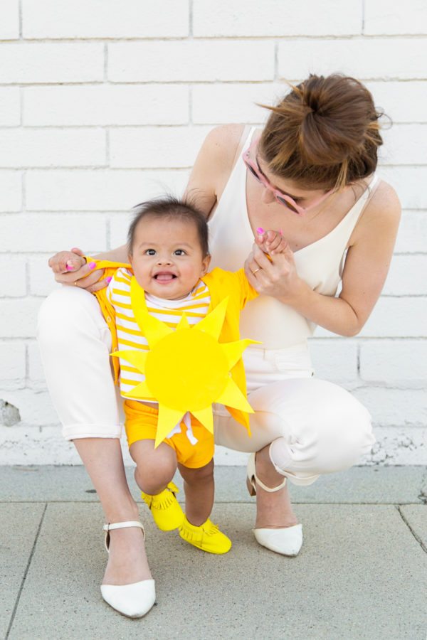 A little boy dressed as a sun