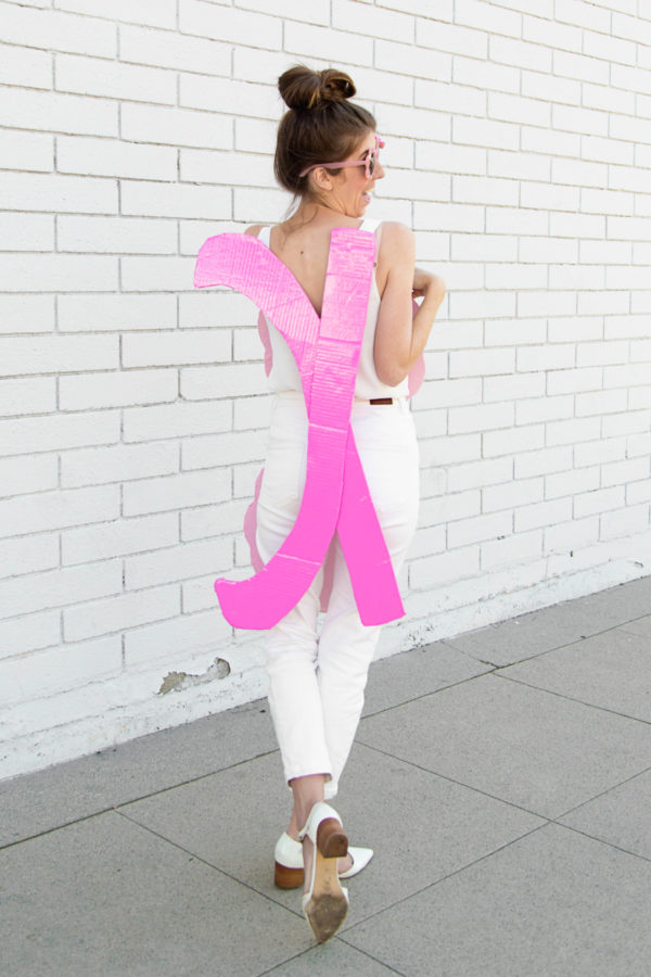 A woman holding pink cardboard 