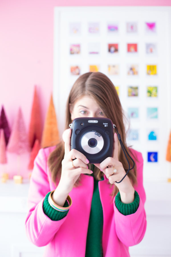 A woman standing in front of an art piece