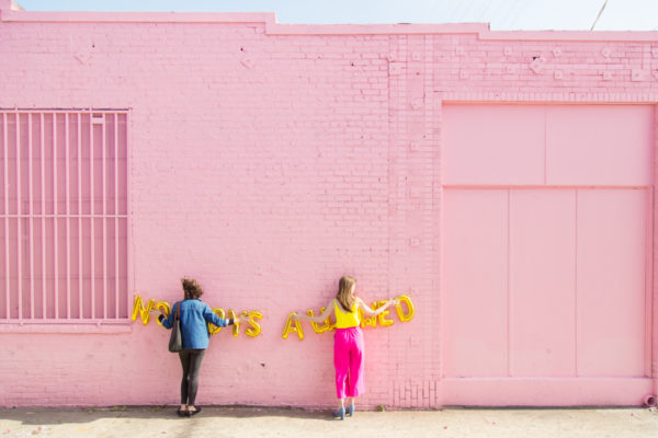 Two people standing in front of a building