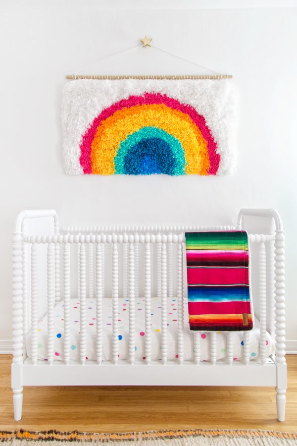 A crib with colorful sheets