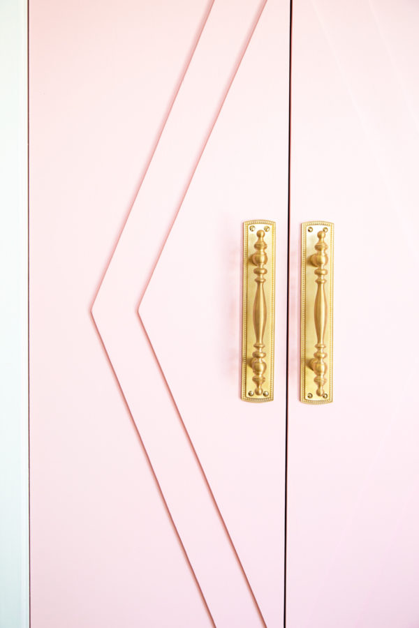 Gold handles on a pink door