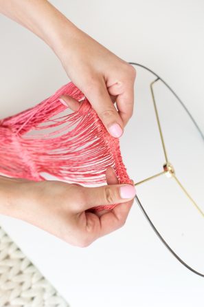 Someone making something with pink string