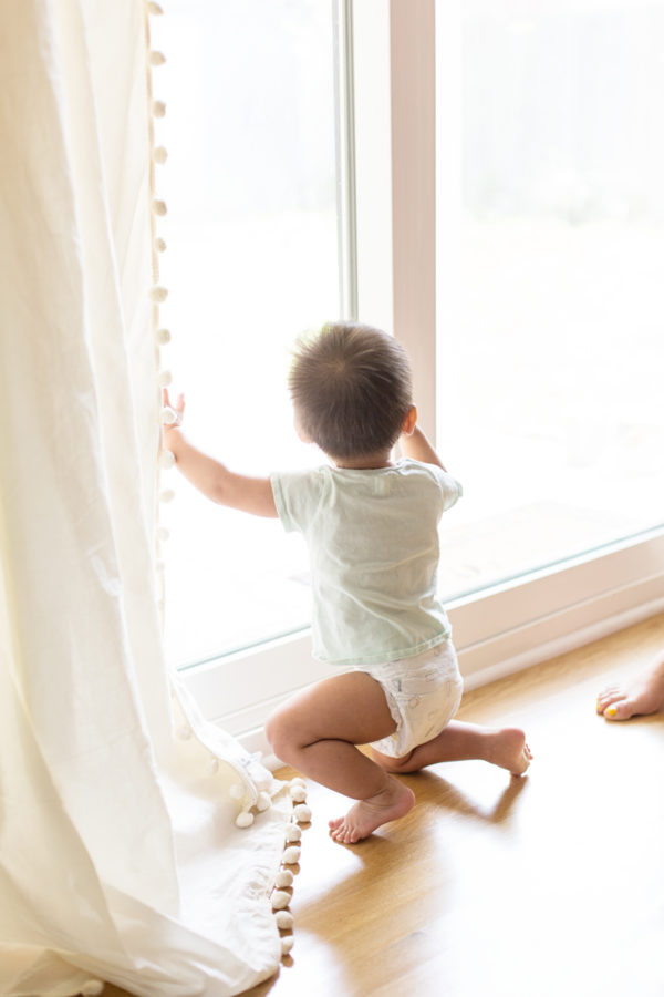 A little boy looking out a window