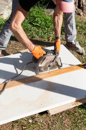 Someone cutting a board