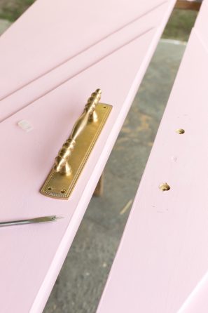 Gold handle on a pink door