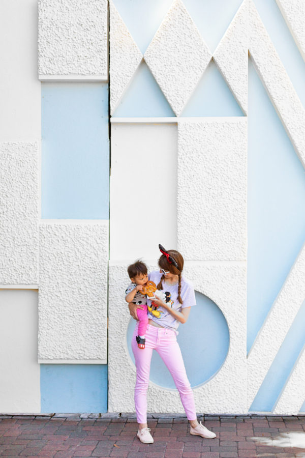 A woman and a little boy in front of a blue and white wall