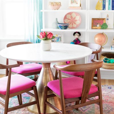 A table with pink chairs