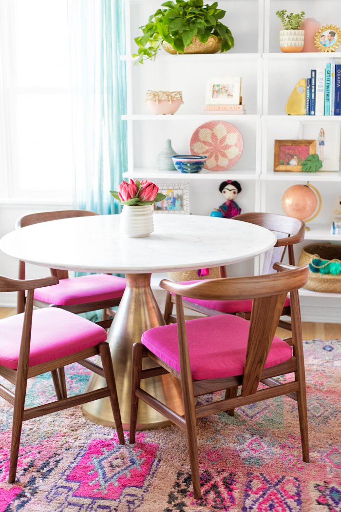 A table with pink chairs