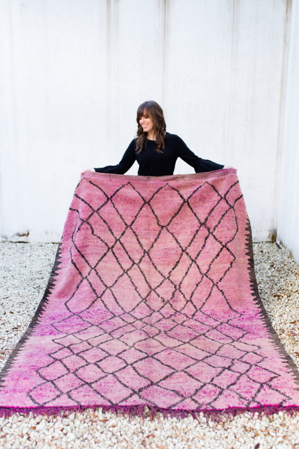 Someone holding a pink rug