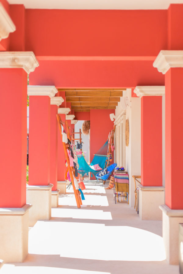 A pink building with posts