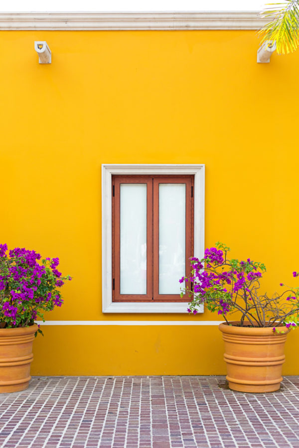 A yellow wall with a window