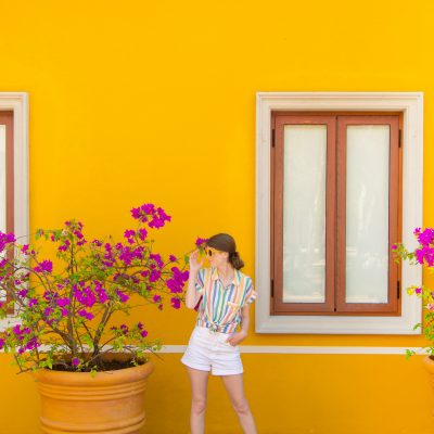 A person standing in front of a yellow wall