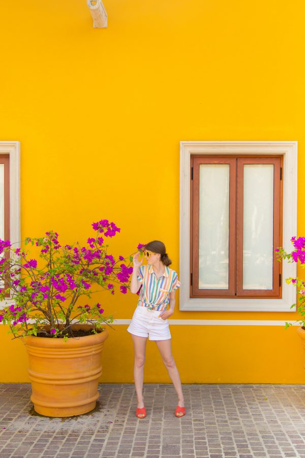 A person standing in front of a yellow wall