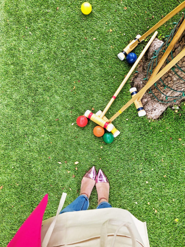 A photo of someone wearing pink heals on the grass