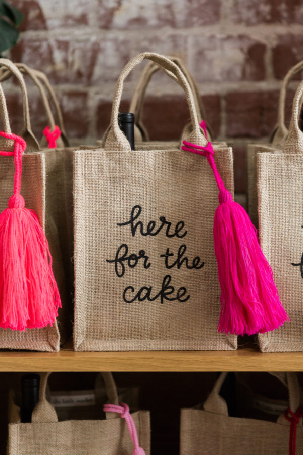 A bag with the words \"here for the cake\" on it
