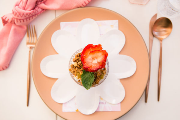 A plate with strawberries and granola