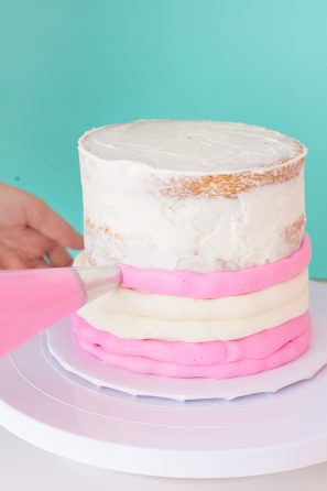A cake with pink and white frosting