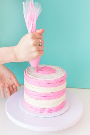 A person decorating a cake