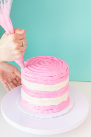 A person decorating a cake