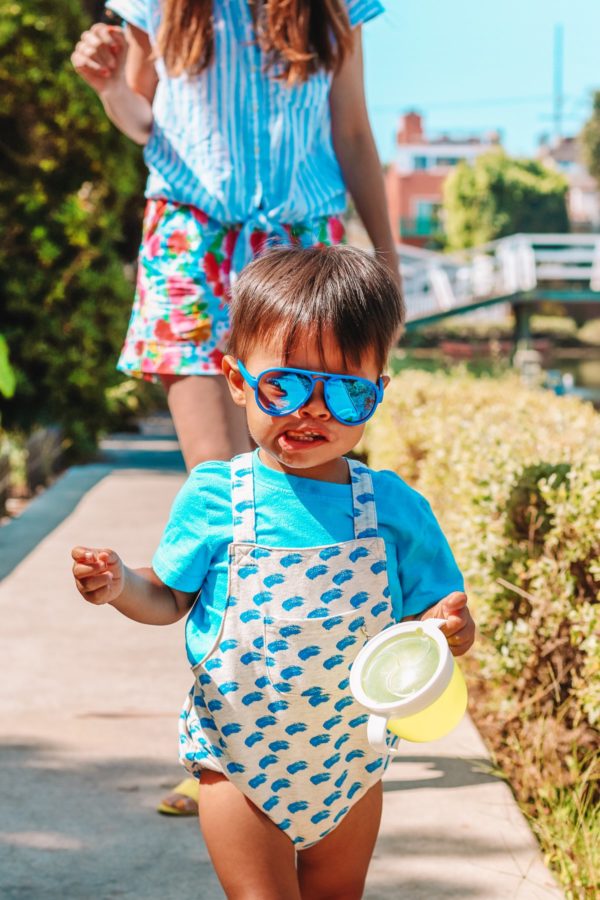 A little boy wearing sunglasses