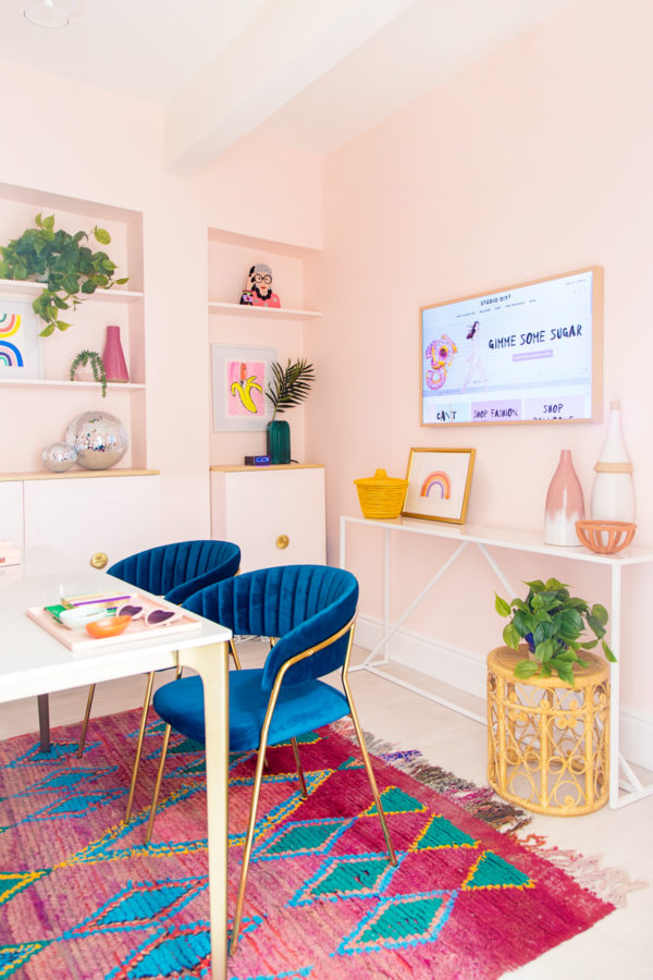 A room filled with blue chairs and a tv