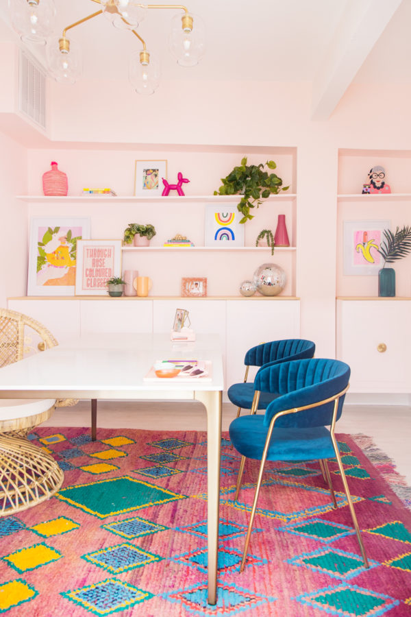 A room filled blue chairs and colorful rug