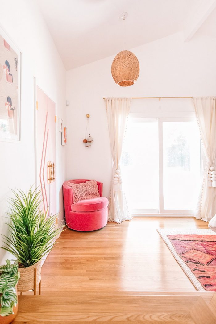 A pink chair in a corner