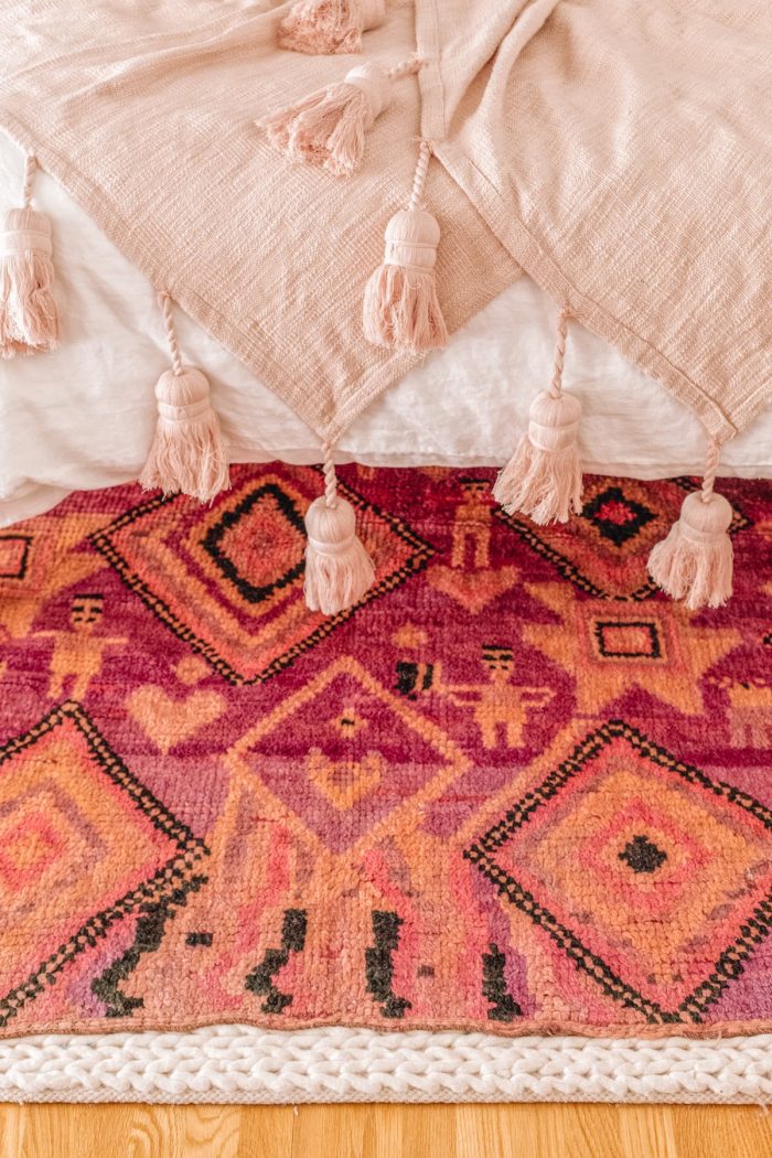 Close up of a pink blanket and a rug