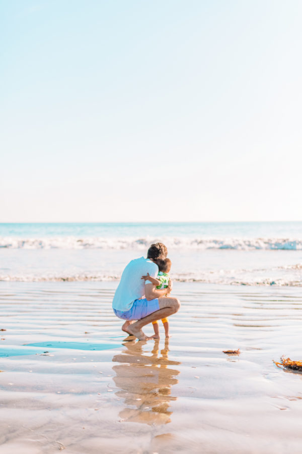 Two people standing on a beach