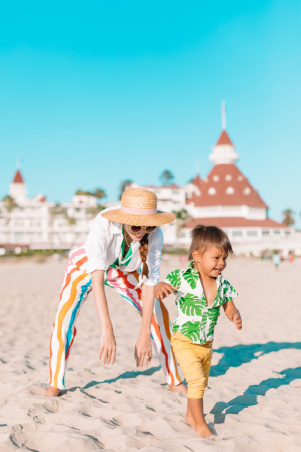 A little boy that is standing in the sand