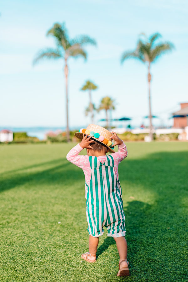 A little boy that is standing in the grass