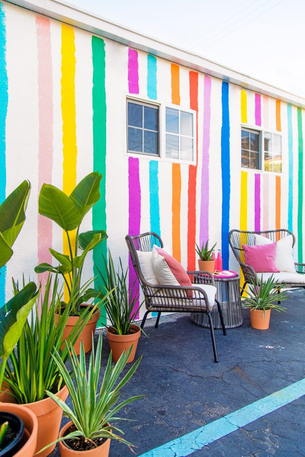 Two chairs in front of a colorful wall