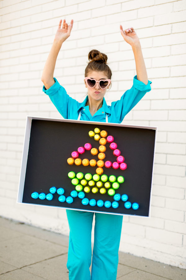 A person holding a light brite sign