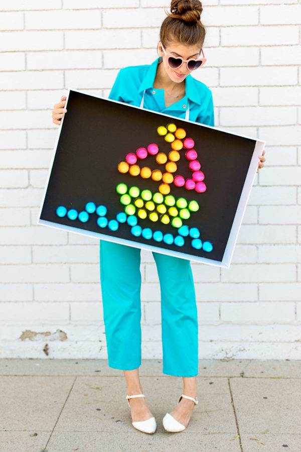 A person holding a lite brite