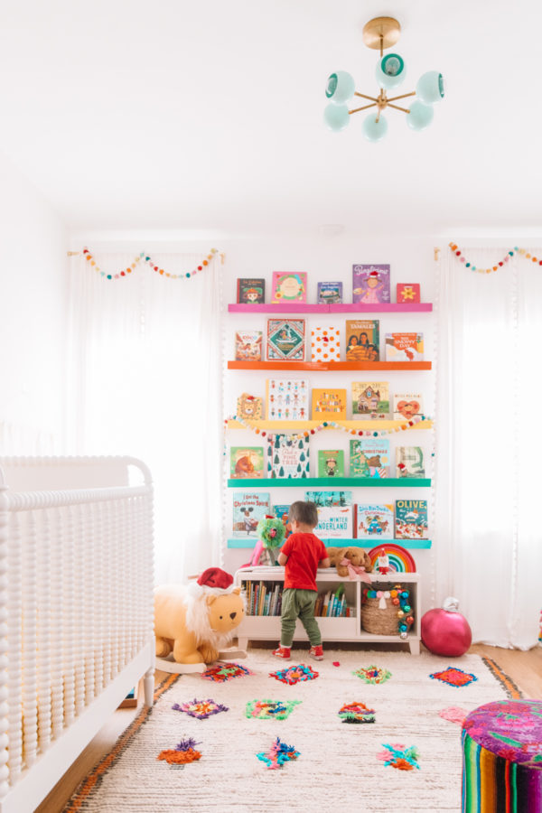 A bedroom with rainbow shelves