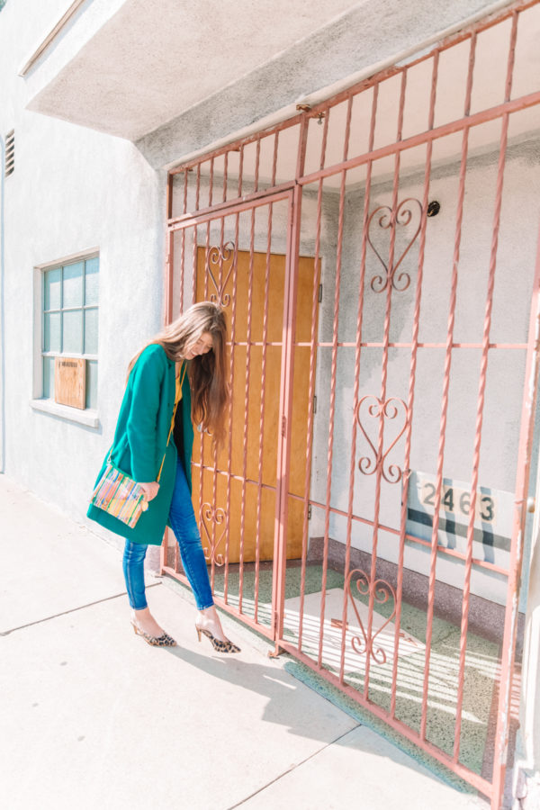 A person standing in front of a pink gate